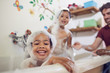 © Trevor Adeline/Caia Image - Portrait playful girls taking bubble bath