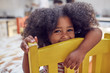 © Trevor Adeline/Caia Image - Portrait cute girl on yellow chair