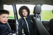 © Sam Edwards/Caia Image - Portrait confident boy in fur hooded jacket in back seat of van