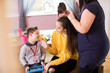© Sam Edwards/Caia Image - Happy family with Down Syndrome child bonding in dining room