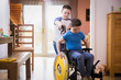 © Sam Edwards/Caia Image - Boy pushing brother with Down Syndrome in wheelchair