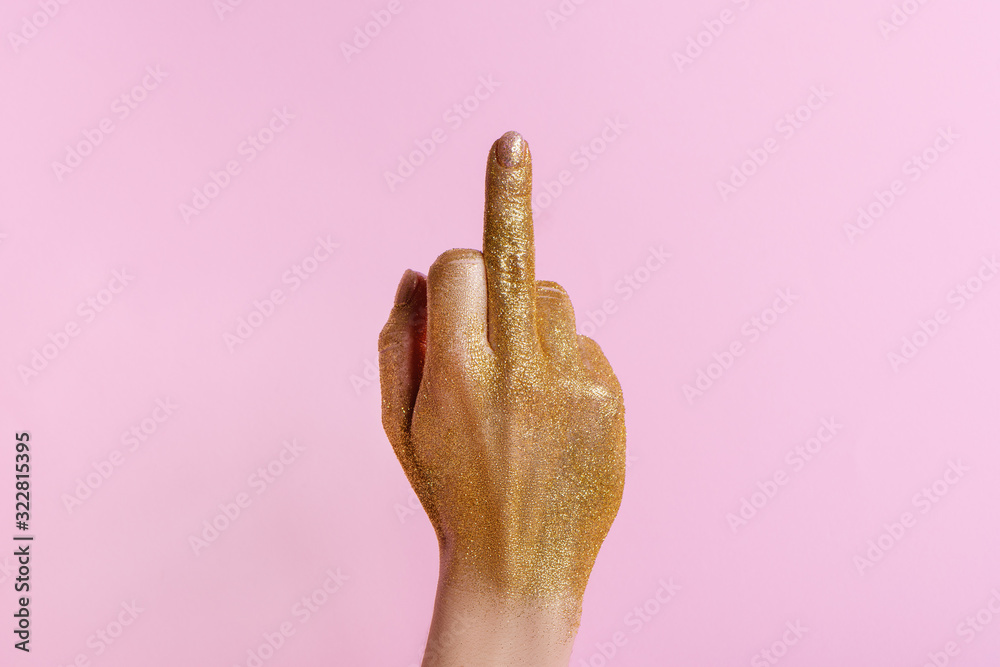 Woman hand gesturing with middle finger hole on pink background. - obrazy, fototapety, plakaty 
