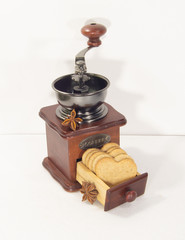 Coffee grinder and cookies for Valentine's Day on white background.