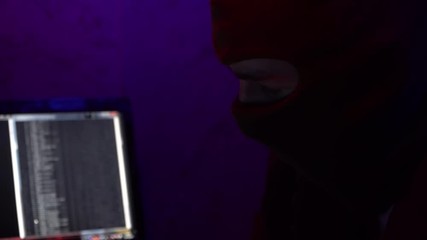 Hacking a computer system. Stealing digital data. Crime.The background reads all the data.Close-up