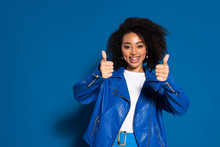 Smiling African American Woman Showing Thumbs Up On Blue Background