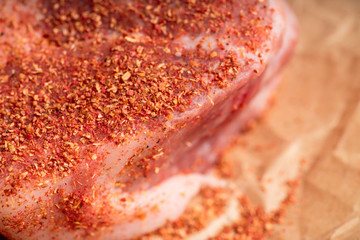 Wall Mural - Raw fresh meat with spices on the rustic background. Selective focus. Shallow depth of field.