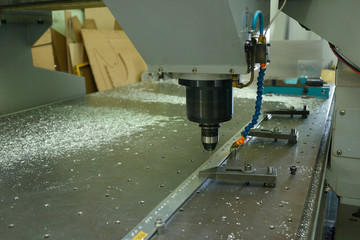 Computer numerical control milling machine set for work, drill boring hole in a metal piece