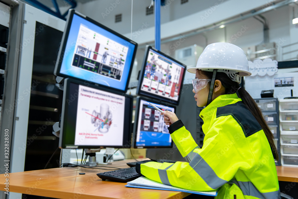 Inside the large Industry Factory Female Computer Engineer Works on ...