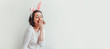 © Юлия Завалишина - Happy Easter holiday celebration spring concept. Young woman wearing bunny ears isolated on white background. Preparation for holiday. Girl looking happy and excited having fun on Easter day. Banner