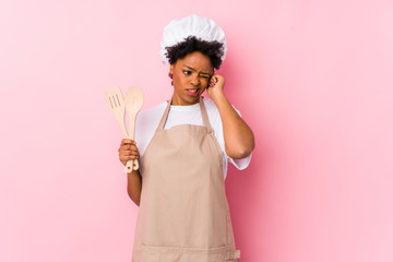 Wall Mural - Young african american cook woman covering ears with hands.