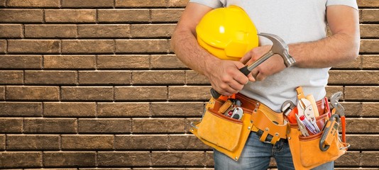 Wall Mural - Man worker and professional builder with tools