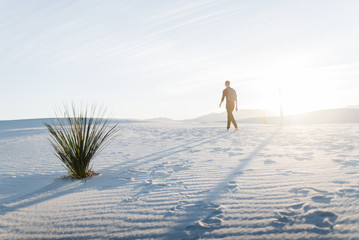 Wall Mural - A man walking at White Sands National Park in Alamogordo, New Mexico. 