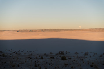 Wall Mural - Full moon during sunset at White Sands National Park in Alamogordo, New Mexico. 