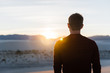 © Rosemary - A man looking into the sunset at White Sands National Park in New Mexico.