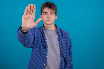 Wall Mural - young teenager or student boy in casual style isolated on color background