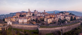 Fototapeta  - Bergamo, Italy. Drone aerial view of the old town during sunrise. Landscape at the city center, its historical buildings and the Venetian walls a Unesco world heritage
