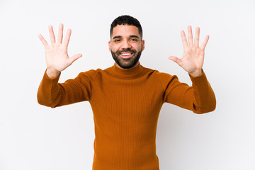 Wall Mural - Young latin man against a white background isolated showing number ten with hands.