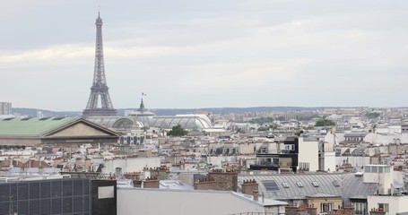 Wall Mural - Paris rooftops view and Eiffel Tower in a cloudy day in France