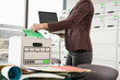© SuperStock - Tight shot of a woman holding a laptop sorting through a box., Jacksonville, Florida, USA