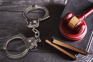 Sticker - Wooden judge hammer with handcuffs and books on the desk