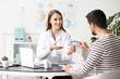 © Pixel-Shot - Ophthalmologist explaining patient how to use contact lenses