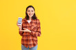 © Pixel-Shot - Young woman with menstrual calendar on mobile phone screen against color background