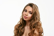 © ANR Production - Portrait of young beautiful woman isolated at white background. Blonde girl with long and shiny wavy hair . Smiling friendly girl with curly hairstyle