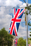 Fototapeta Londyn - Union Jack flag of the United Kingdom of Great Britain hanging from pole with tassels on the Mall in London