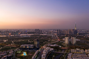 Wall Mural - Aerial view to new luxury real estate developments along the Saigon river from Thu Thiem district, in Ho Chi Minh City, Vietnam at twilight