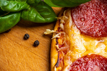 Wall Mural - Fresh pepperoni pizza served on the wooden board. Selective focus. Shallow depth of field.