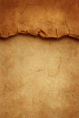 Wall Mural - Vertical oriented template from torn crumpled edge of old ancient vintage paper on another sheet of antique paper. A header for a site, banner, flyer, social network, menu or booklet.