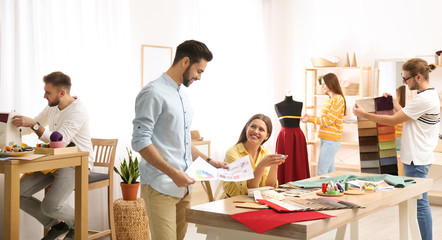 Wall Mural - Fashion designers creating new clothes in studio