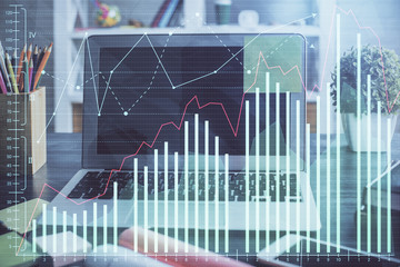 Double exposure of chart and financial info and work space with computer background. Concept of international online trading.