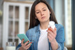 © zinkevych - Woman looking for the instruction for drugs using her smartphone