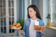 © zinkevych - Woman holding plates with gluten free bread