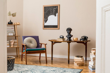 Interior design of stylish library room with retro armchair, wooden table, bookstand, books, mock up poster map, vintage carpet and elegant personal accessories. Beige wall. Home decor. Template.