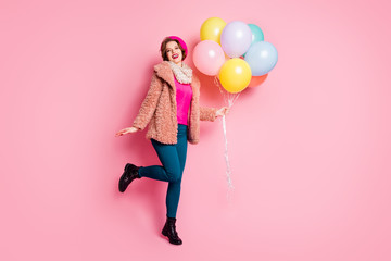 Wall Mural - Full body photo of cute pretty lady hold many colorful air balloons birthday surprise wear modern fur coat scarf beret cap pants shoes clothes isolated pink color background