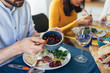 © cherryandbees - close up of caucasian mixed aged family and friends having vegetarian dinner party at home