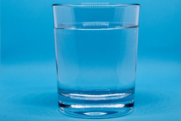 glass of water on blue background