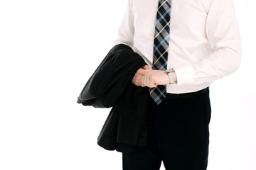 A businessman in a suit looks at the watch on his hand on a white background.