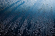 close up of raindrops on blue car bonnet