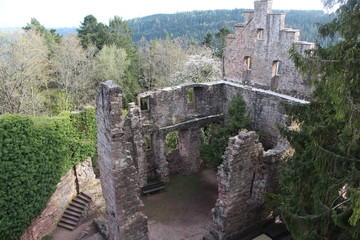 The ruins of an old castle on top of a mountain. The ruins of a medieval fortress in a forest among nature. Historic site, destroyed walls.