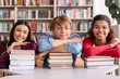 © Pixel-Shot - Young students with books in library