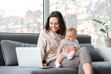 Wall Mural - Working mother with her baby in office