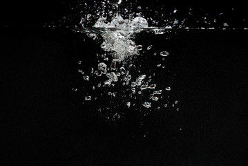  something falls into the water and causes seething and air bubbles on a black background for installation