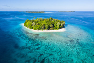 Seen from the air, a remote, tropical island lies amid the Molucca Sea in Indonesia. This beautiful region is thought to be amid the world's epicenter of marine biodiversity.