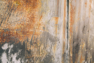 Rusty metal multicolor abstract outdoor textured grunge wall with gray, white, and orange rust pattern to be used as a background with copy space