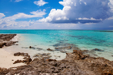 Turquoise blue sea water shore and cloudy sky