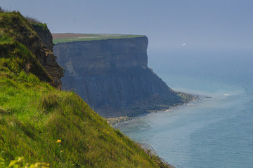  Stunning mountains and cliffs of Normandy coast on a sunny day. Arromanches-les-Bains, France
