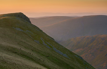 Sticker - The summit of Kidsty Pike at sunrise with Long Stile to the right leading down to Riggindale valeey below in the Lake District UK.